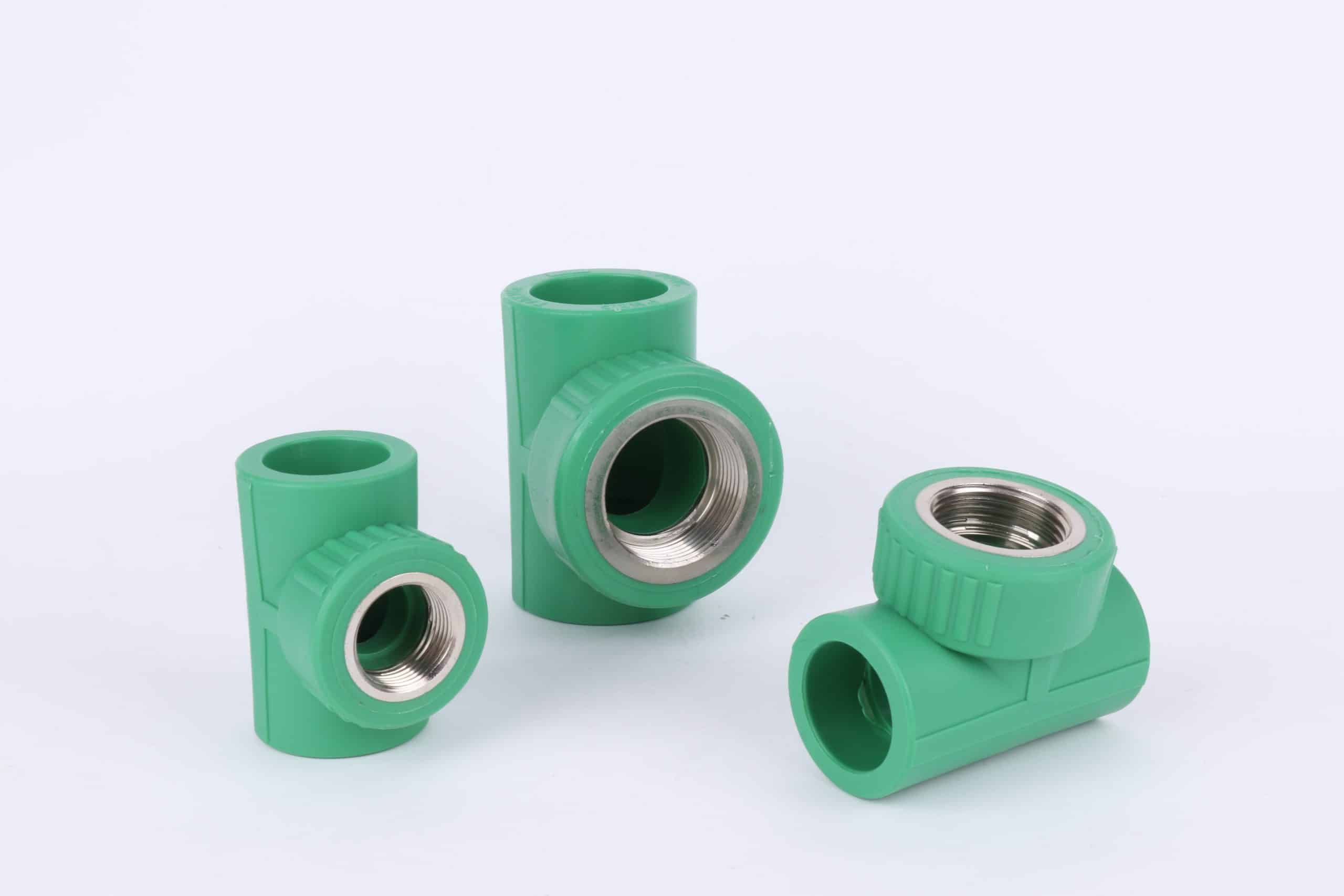 Green PP-R female threaded tees with brass inserts, the fitting families a first container must carry in proportion to its branch pipe