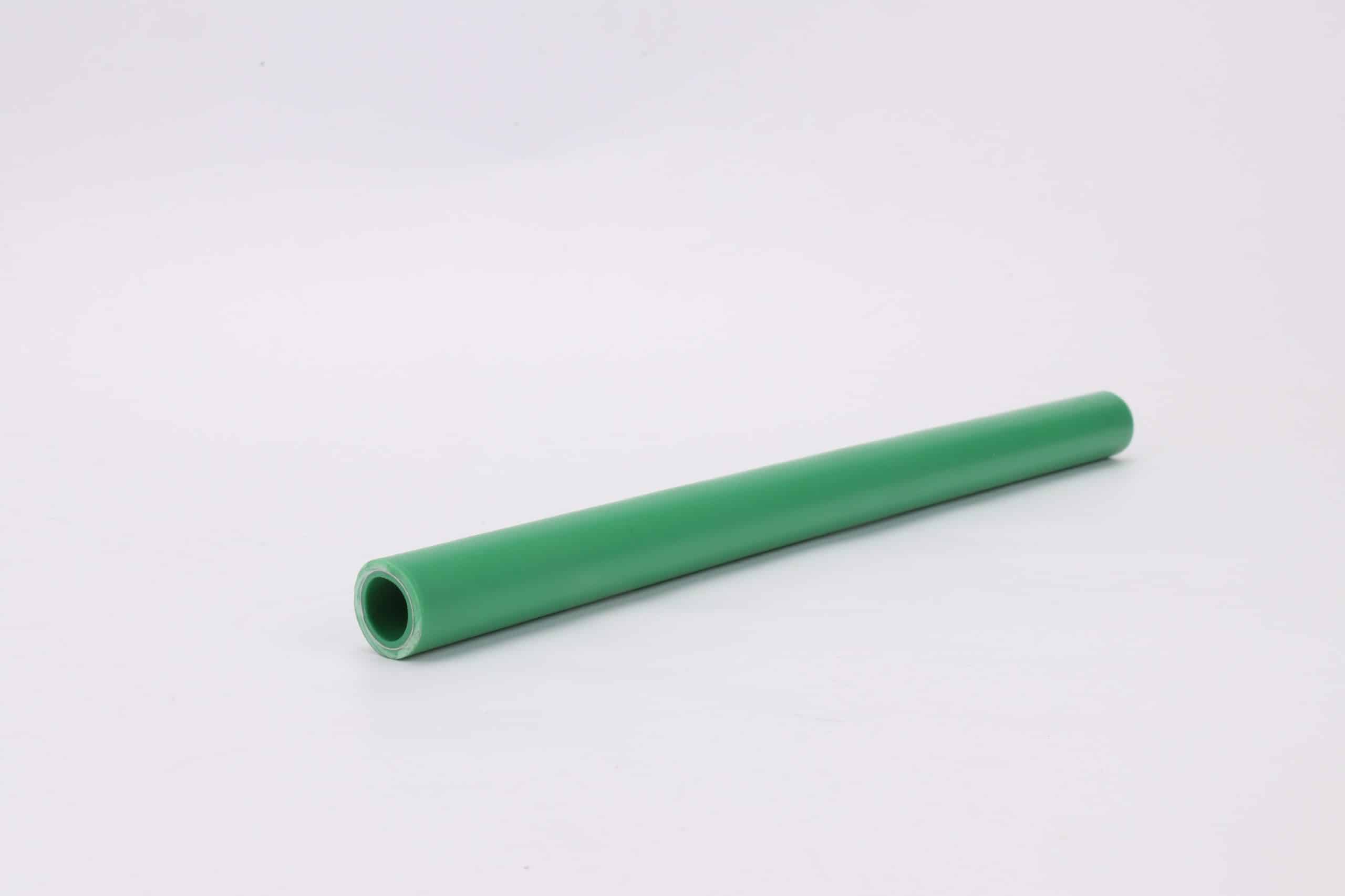 Green PPR polypropylene random copolymer pipe stacked in a warehouse