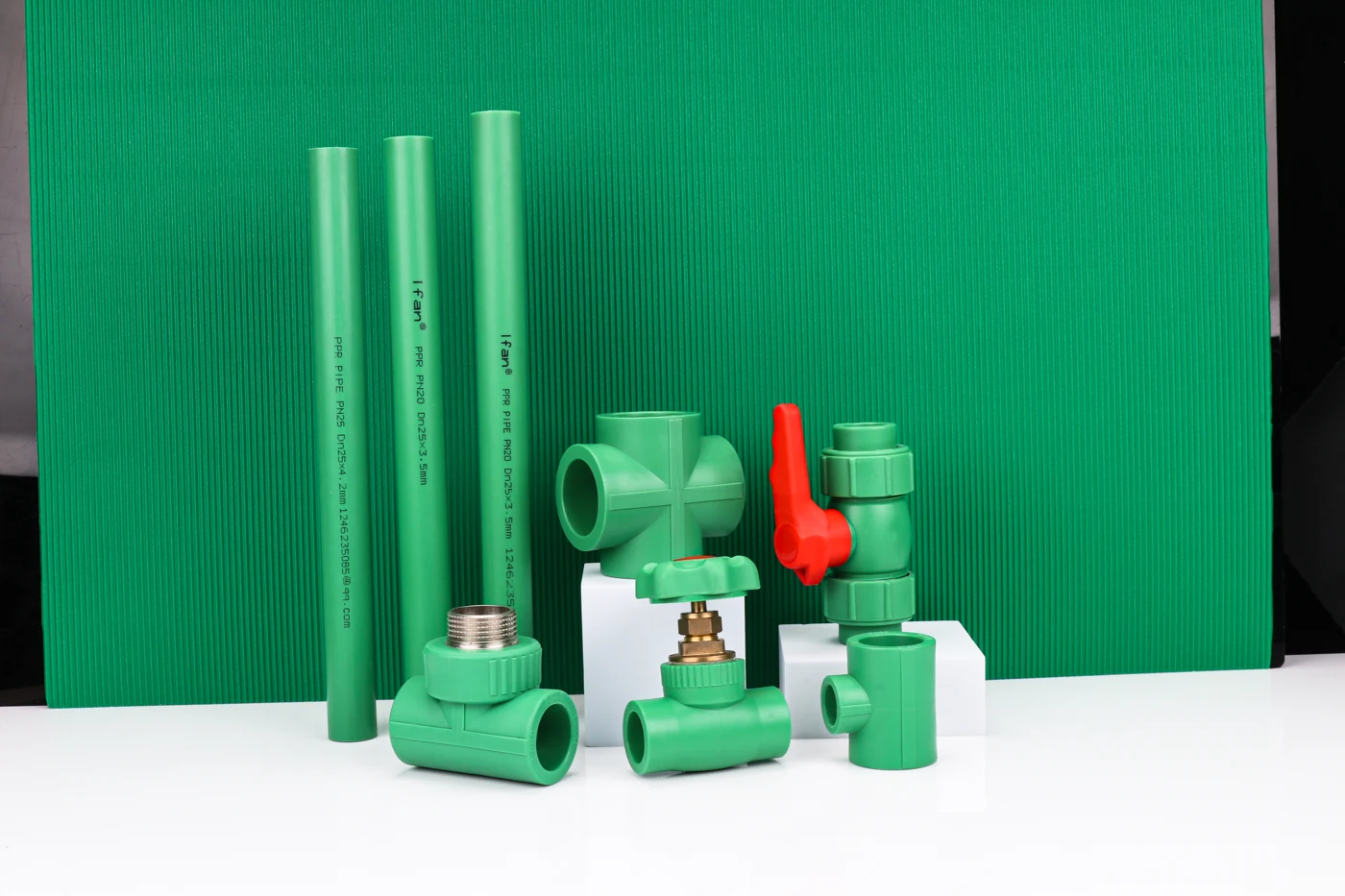 Green PP-R fitting and valve assortment with red valve handle