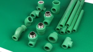 Green pipe sections and fittings arranged on a green background