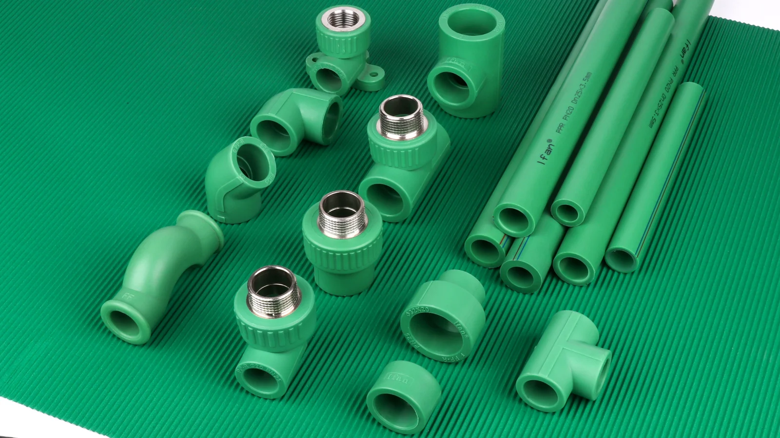 Green pipe sections and fittings arranged on a green background